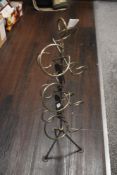 A modern free standing and wrought iron wine rack, having applied oak leaf and berry embellishments,