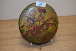 A mid-20th Century Disney themed tin, depicting Donald and Daisy Duck, measuring 16cm in diameter