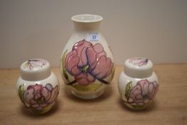 A William Moorcroft ovoid shaped vase, decorated in the Hibiscus pattern against a cream ground