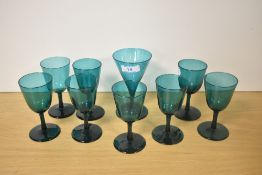 A selection of early 19th Century deep green coloured glasses, the largest measures 14cm high