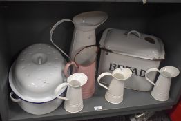 A mid-20th Century enamelled rectangular bread bin, measuring 28cm high, together with a selection