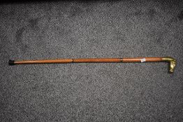 A 20th Century adjustable walking stick with brass horse head handle, measuring 90cm long
