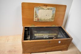 A 19th/20th Century walnut inlaid Swiss musical box, with inlaid stringing, measuring 20cm x 40cm