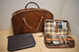 A mid-20th Century crocodile skin hand bag, measuring 38cm long, together with a tan leather