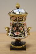 A Royal Crown Derby porcelain urn with cover, in the Traditional Imari pattern, measuring 17cm high