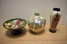 A Cobridge stoneware bulbous shaped vase, having a design featuring large leaves and petals in green