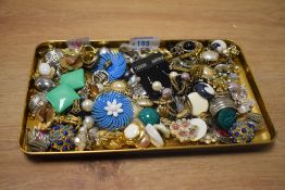 An assortment of costume clip on earrings, including feux pearls, paste set examples and statement