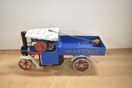 A Mamod Live Steam Wagon in blue and white, burner present