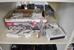 A Nintendo Wii Console with controllers and gun with cables and a collection of Games including Just