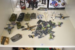 A shelf of Military Die-casts and plastic Figures including Dinky Tanks and Aeroplanes, Britains
