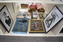A shelf of 007 James Bond Collectables including Goldfinger Special Edition Film Cell, George