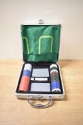 A modern Poker set in metal case with cloth and full deck of cards with chips and dice