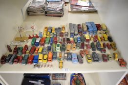 A shelf of playworn Matchbox Lesney die-casts, Commercial Trucks and Wagons, Cars, Buses etc, 80+