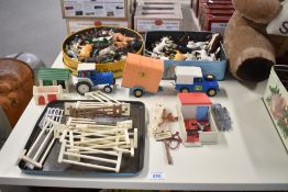 A collection of Britains plastic Farm Animals and Accessories along with a die-cast Ford Tractor and