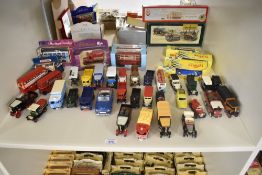 A shelf of modern die-casts including Matchbox KRW-15 The Royal Wedding Bus in original window