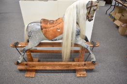 A Victorian Rocking Horse painted grey, having leather saddle and bridle, replacement mane and tail,