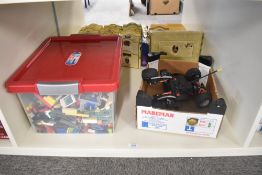 A collection of vintage Lego pieces along with a modern Lego Racers Car with controller