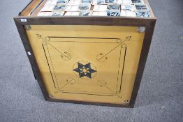 A Karums Karom board with playing pieces in a pocket, 80cm x 80cm dated on reverse 1993