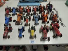 Eighteen playworn Dinky, Matchbox, Britains and similar Tractors including Ford, International,