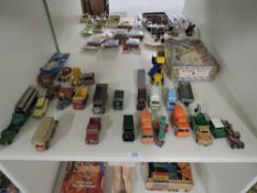 A shelf of playworn Dinky and Corgi die-casts including Dinky 564 Elevator Loader in worn original