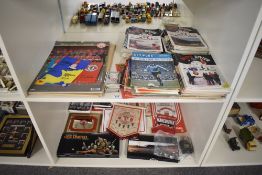 Two shelves of 1970's and later Manchester United Memorabilia including a large collection of