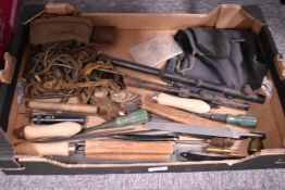 A box containing some gunsmiths files, old scopes and gun cleaning accessories