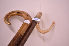 Two horn handled walking sticks one with painted deccoration measuring 110cm and 127cm