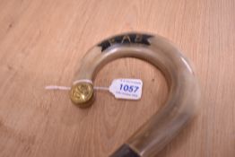 A crook style horn handled walking stick measuring 122cm long and having a naval style military