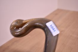 An unusual walking stick with a carved birds head handle