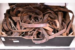 A large selection of used leather straps mostly removed from rifles and gunsleeves