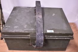 A green military style ammunition box with leather strap and key