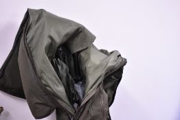 A Large Carp Kinetics rod bag containing two fishing umbrellas rod rests and keep net