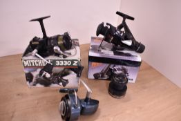 Three spinning reels a Daiwa PG1650 boxed with spare spool, a Mitchell 3330z boxed and a Roddy 805A