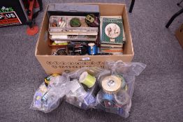 A box of assorted tackle including vintage reels, line, weights, lures and books
