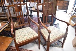 A pair of Edwardian mahogany carver chairs having drop in tapestry seats