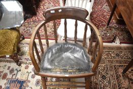A vintage oak spindle back office armchair