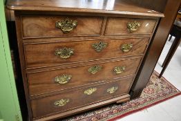 A 19th Century mahogany chest of two over three drawers having brass handles and escutcheons,