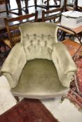 A late Victorian/Edwardian tub chair having mahogany square tapered legs and later green dralon