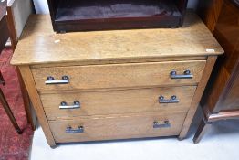 An early 20th Century oak chest of three long drawers, having later deco style handles, dimensions