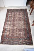 A Persian fireside style rug , worn