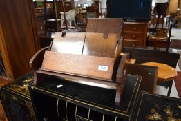 An early 20th Century oak stationery rack and a mahogany book trough