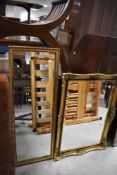 A gilt framed wall mirror, approx. 95 x 35cm and A gilt framed wall mirror, approx. 79 x 56cm