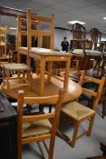 A vintage golden oak pedestal dining table having circular top, diameter approx. 109cm, sold with