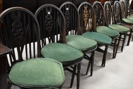 A set of nine (eight plus one) dark stained wheelback dining chairs (possibky Ercol)