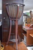 A reproduction torchere with brass jardiniere