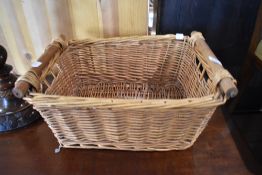 A wickerwork two handled storage basket
