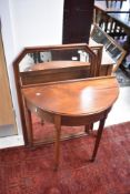 A modern mahogany demi lune hall table and two mirrors