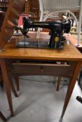 A vintage Singer Sewing machine with integral table
