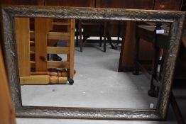 A modern wall mirror having silvered foliate finish, approx 86 x 60cm
