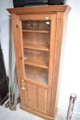 A modern pine bookshelf/display cabinet, height approx. 184 x 76cm